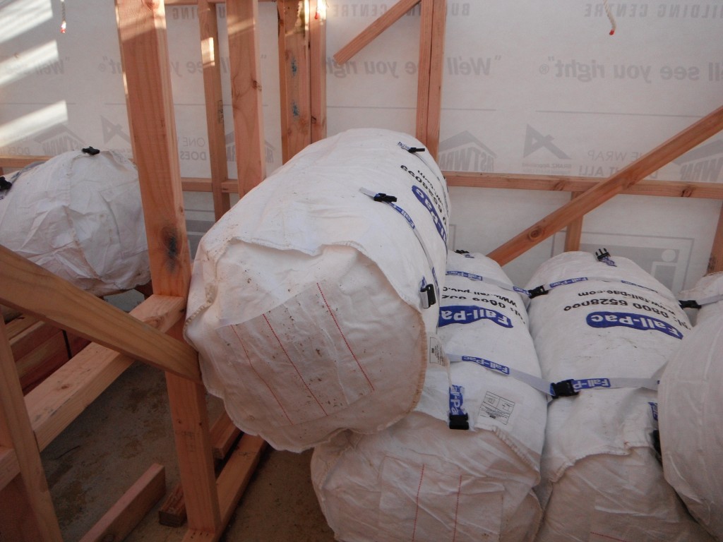 Air-filled fall protection bags stacked beneath a residential build