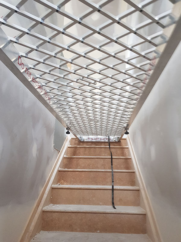 Oxford Safety stairwell platform installed in a stairwell during construction